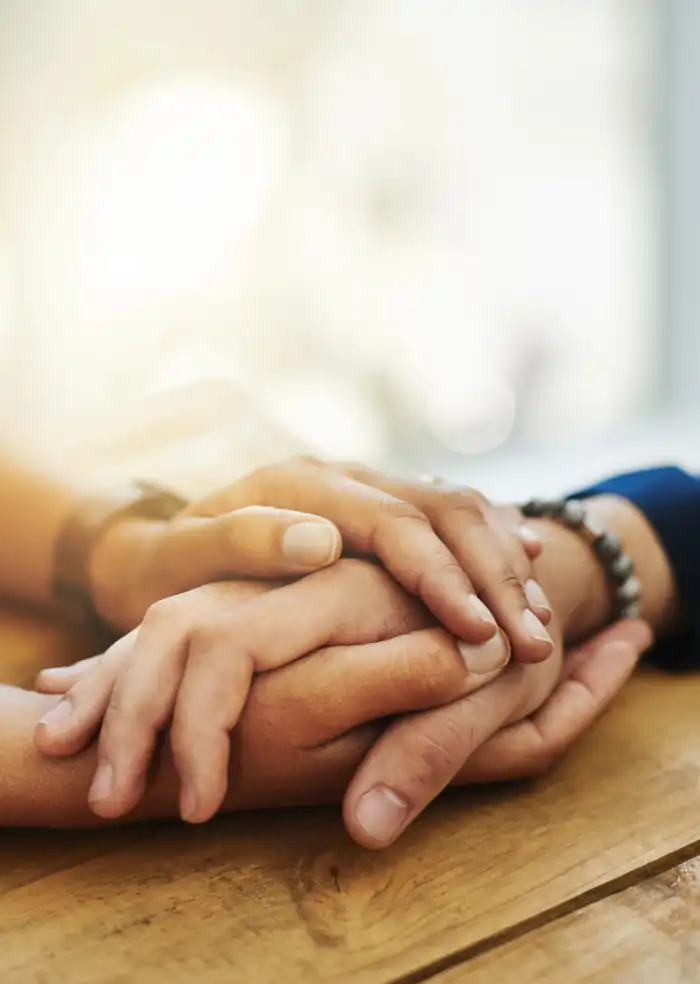 Gentle hands symbolizing compassion, trust, and personal care throughout the cremation planning process