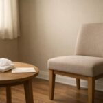 Quiet private viewing room with an empty chair, folded tissue, and sealed envelope before cremation services Dallas, TX